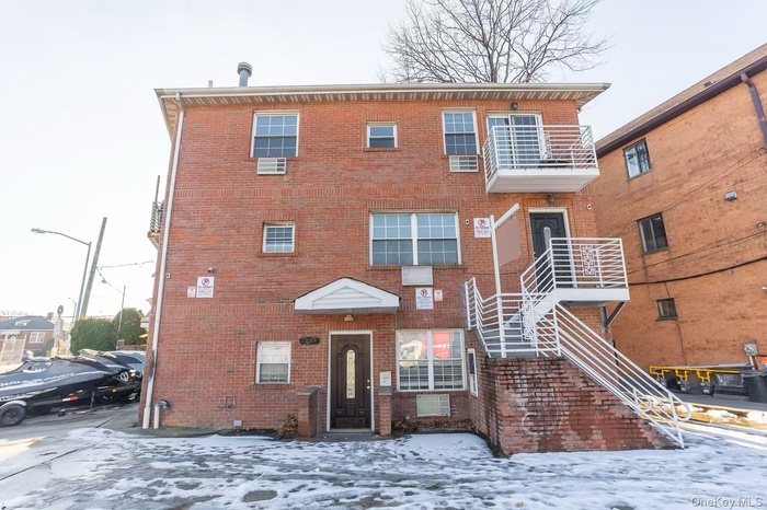 Snow covered property with stairs