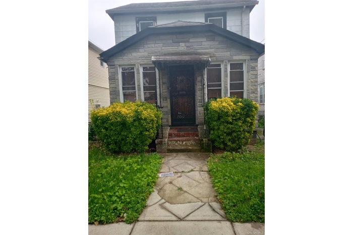 Entrance to property featuring stone siding
