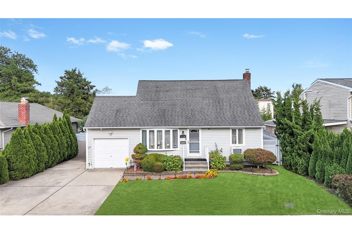 Cape cod home featuring a front yard, driveway, a chimney, and roof with shingles