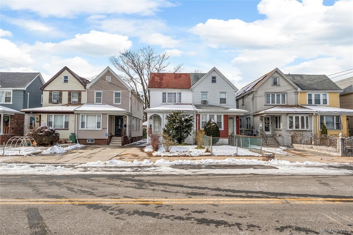 View of front facade with a residential view, a gate, and a fenced front yard