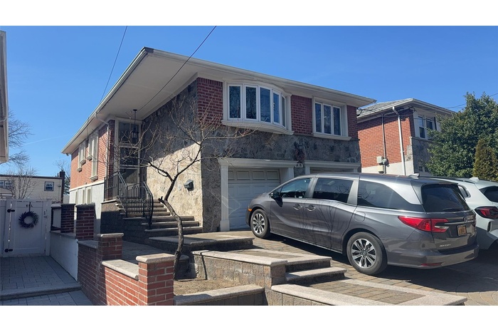 View of front of home featuring a garage and driveway