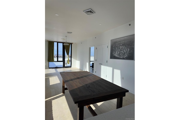 Dining room with light wood-style floors and expansive windows