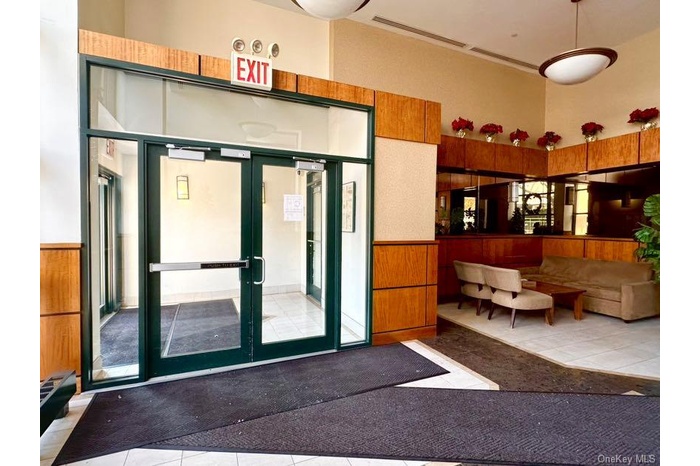 Lobby featuring a towering ceiling and wainscoting