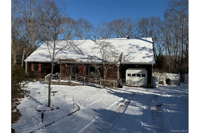 Rustic home with a deck and an attached garage