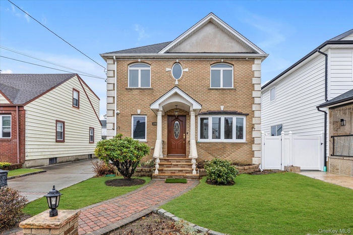 View of front facade featuring brick siding