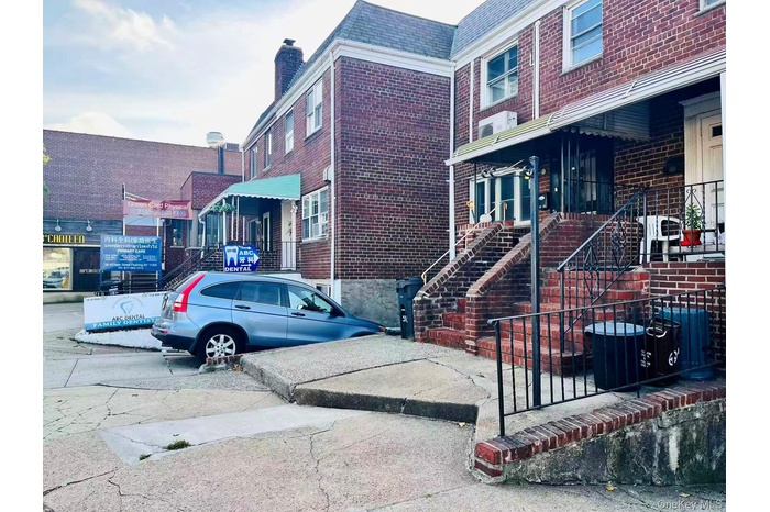 View of property exterior featuring brick siding and a central air condition unit