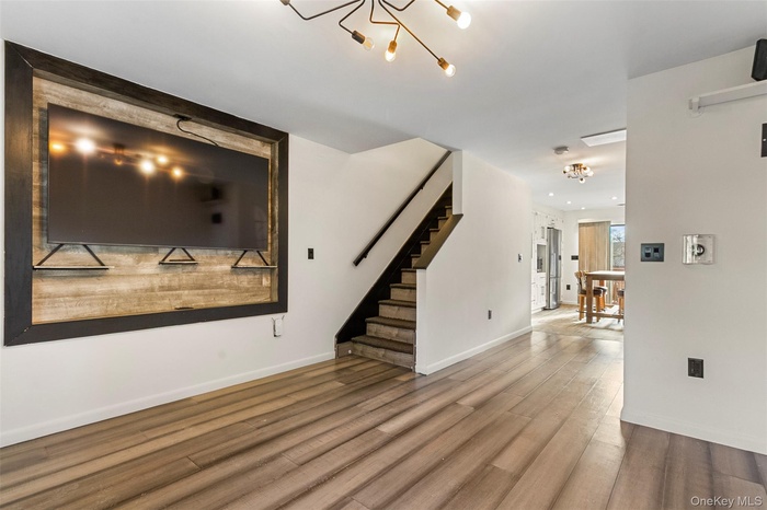 Upon entry, the home opens nicely into a light-filled open floor plan
