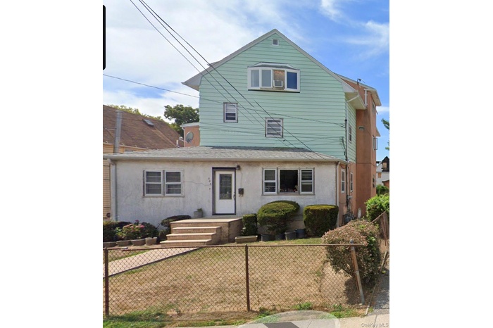 View of front of house with a fenced front yard and stucco siding