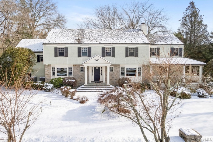 Stately and serene, 103 Pleasant Ridge Road captivates from the street with its substantial stone wall and copper gutter detailing