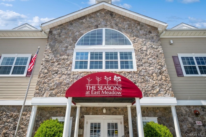 Property entrance featuring stone siding and french doors