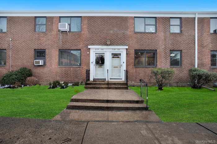 Traditional-style home with a front lawn and brick siding