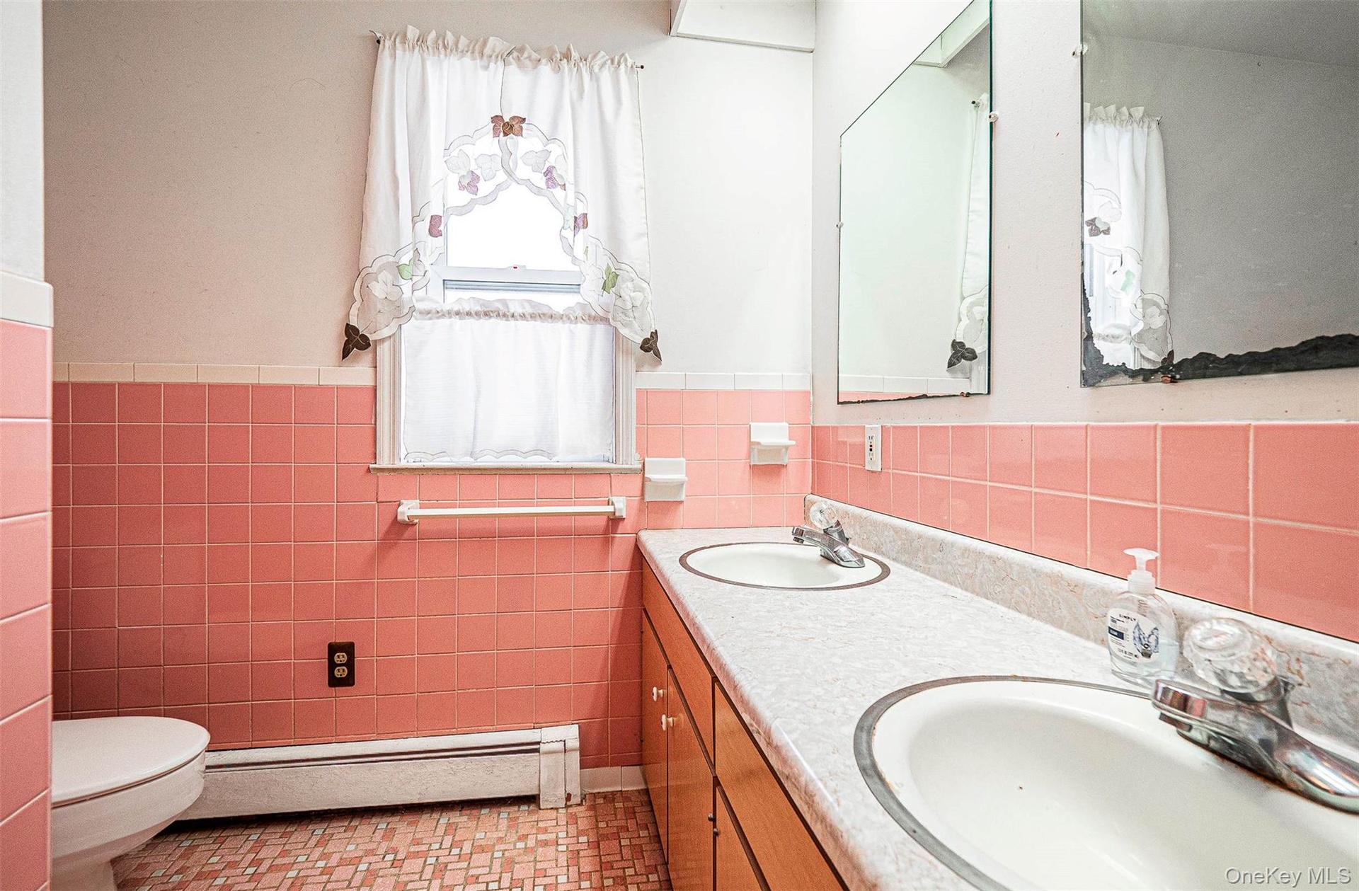 Full bath with double vanity, and tile walls