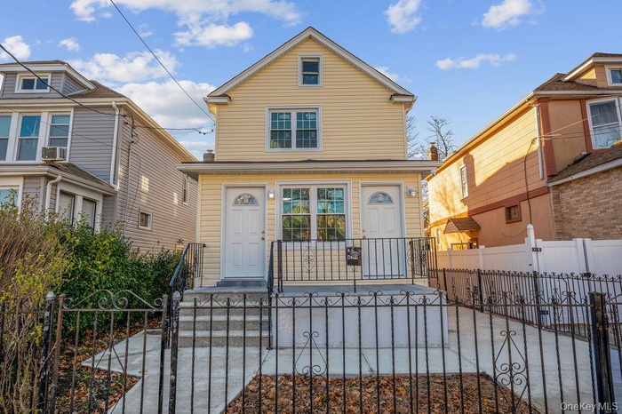 View of front facade with a gate and a fenced front yard