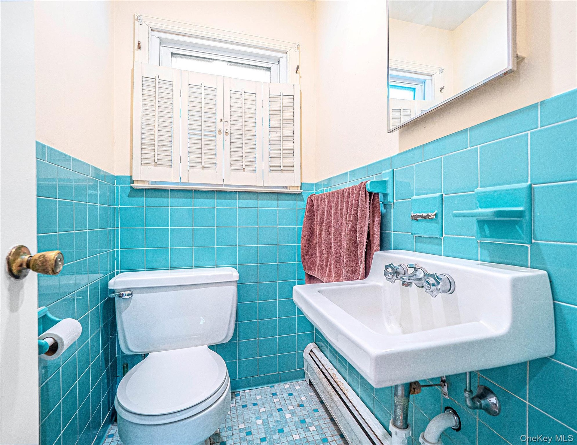 Bathroom with tile patterned floors, and tile walls