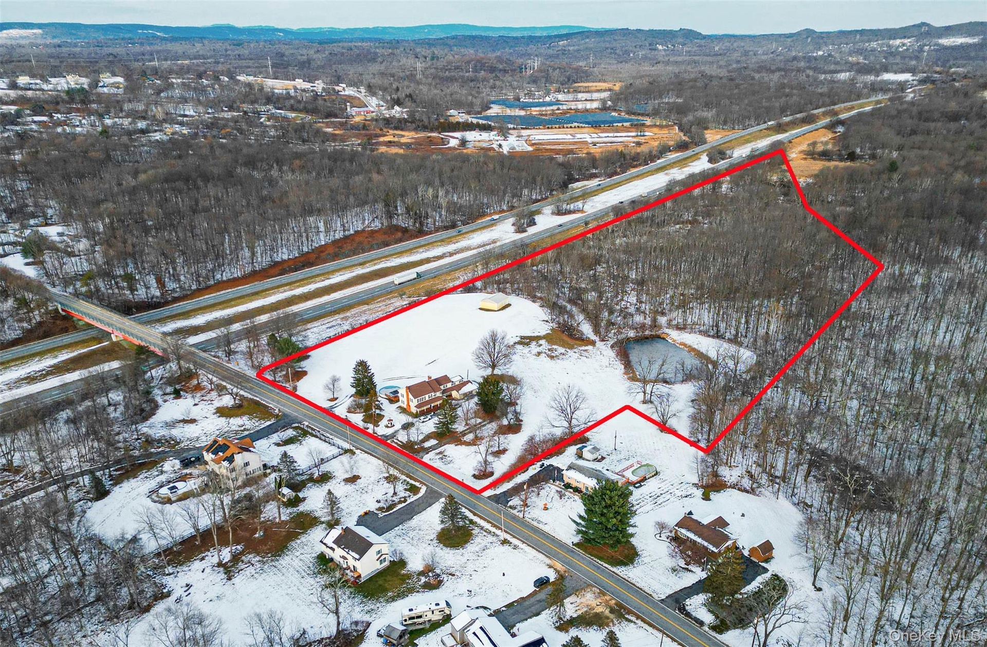 Snowy aerial view with property boundaries highlighted.