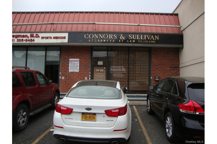 View of building exterior with uncovered parking