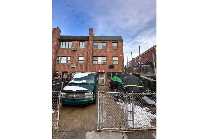 View of apartment building / complex with a fenced front yard