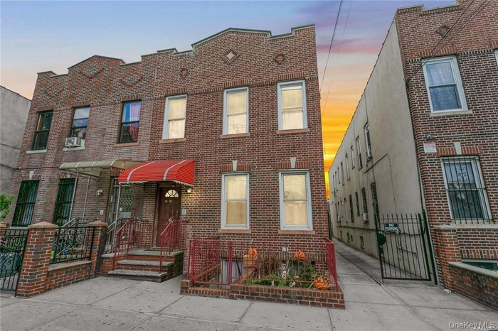 Traditional home with a gate and brick siding