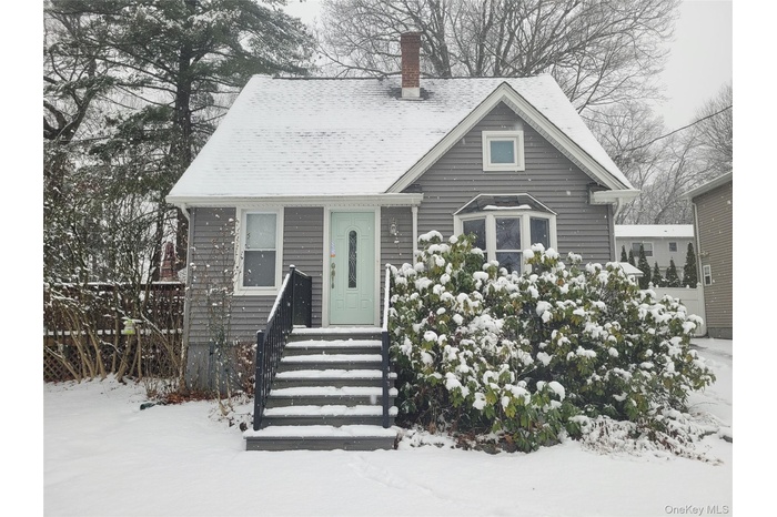 View of front of home featuring a chimney