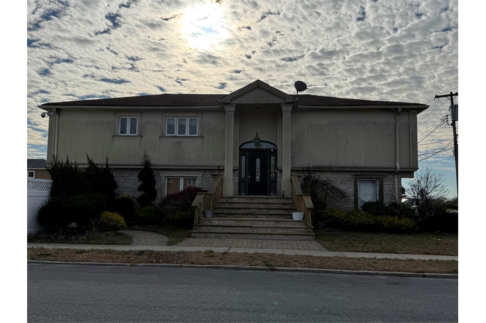 Bi-level home featuring brick siding