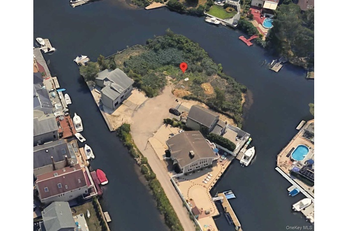 Aerial view of property's location with a large body of water
