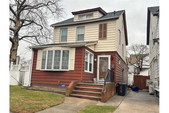 American foursquare style home with a gate