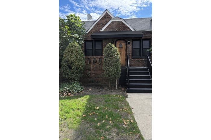 Single story home with brick siding