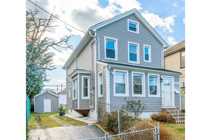 View of front facade featuring entry steps and a storage unit