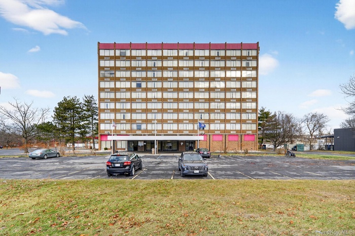 View of commercial property featuring uncovered parking