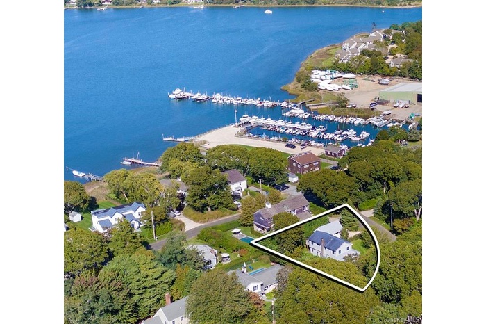 Aerial view of property's location featuring a nearby body of water and property parcel outlined