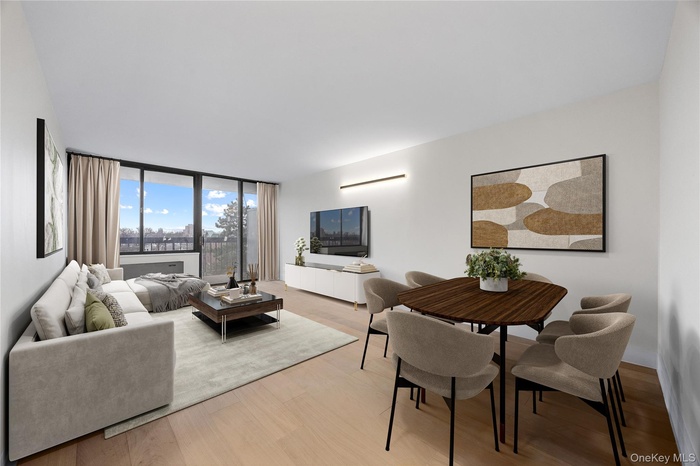 Living room featuring light wood finished floors and floor to ceiling windows