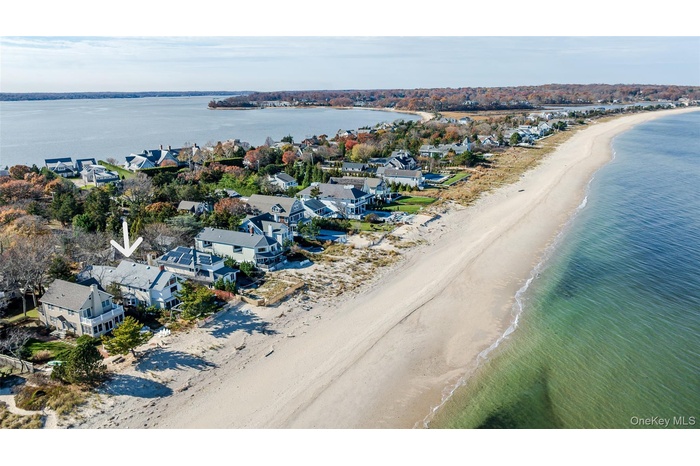 Aerial perspective of suburban area featuring waterfront with a beach