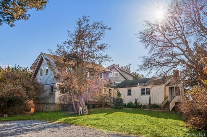 Back of property featuring a yard and a chimney