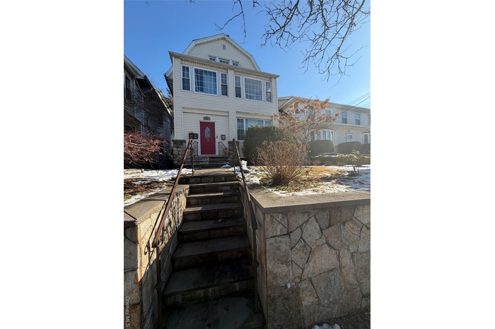 View of front of house featuring a gambrel roof