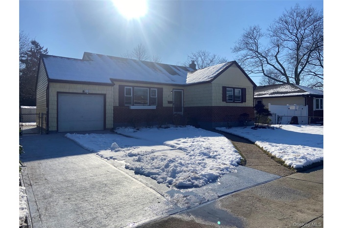 Single story home with an attached garage, brick siding,