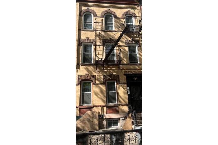 View of side of home featuring brick siding
