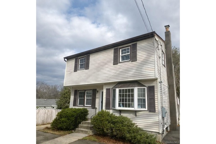 Colonial home featuring a chimney
