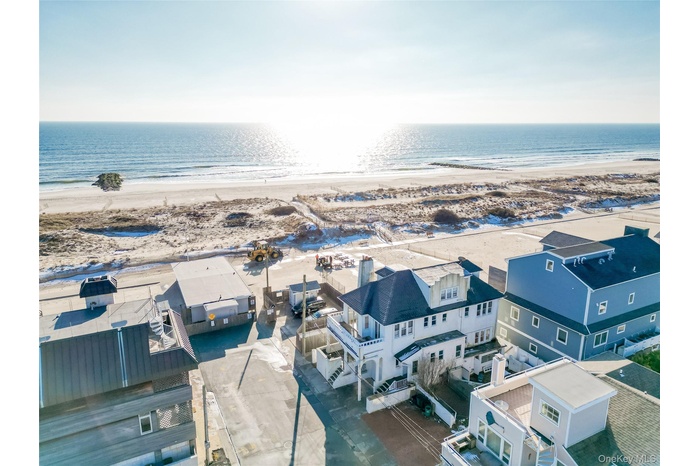 Aerial view of residential area featuring waterfront with a beach