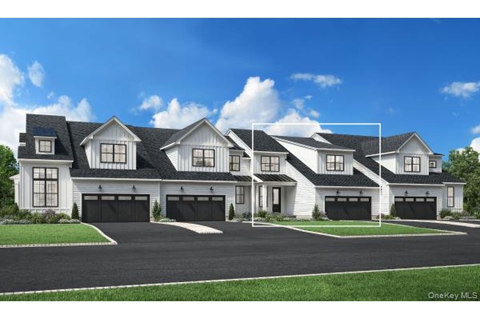 Modern farmhouse featuring driveway, an attached garage, and a front yard