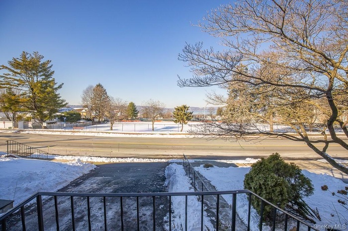 Snowy yard with a balcony