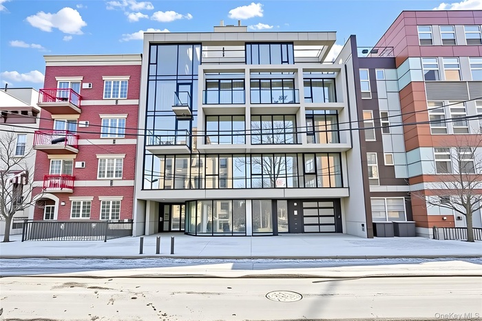 Snow covered building with a view of apartment building / complex