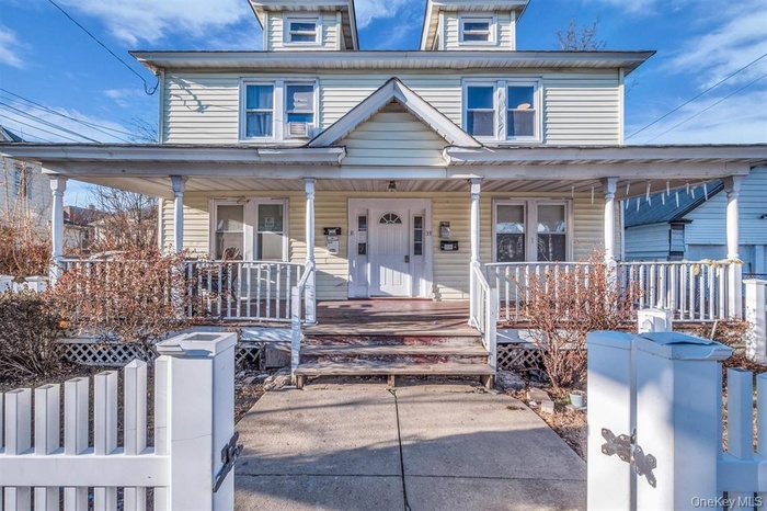 Traditional style home featuring covered porch