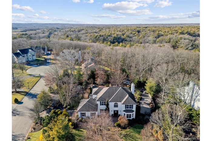 View from above of property featuring a heavily wooded area