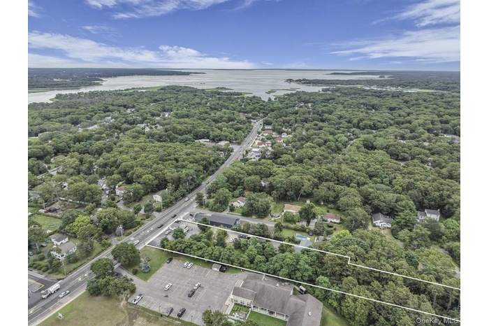 Aerial view of property's location featuring a nearby body of water and property boundaries highlighted