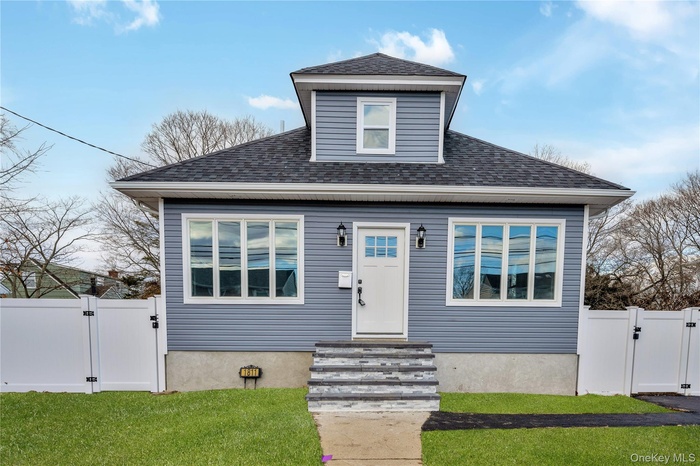 Bungalow-style home with a gate and roof with shingles