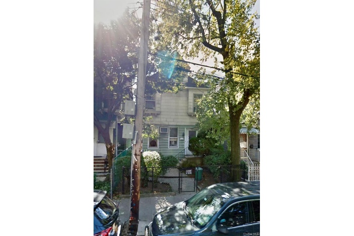 View of front facade featuring a fenced front yard and a gate