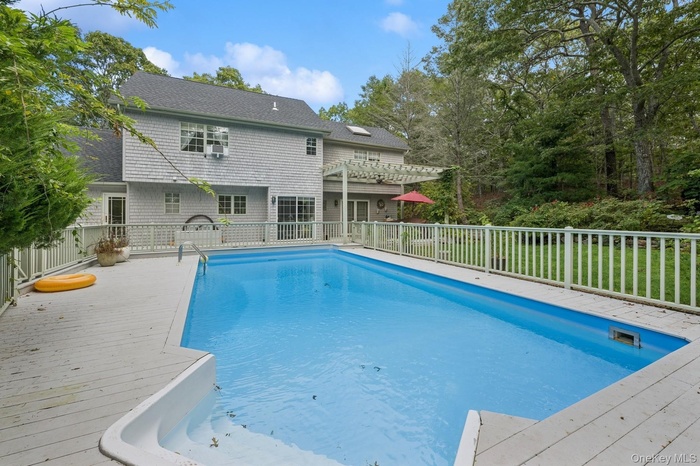 View of pool with a patio, a pergola, and a deck