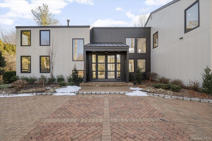 Property entrance featuring a metal roof, a patio, french doors, and a standing seam roof