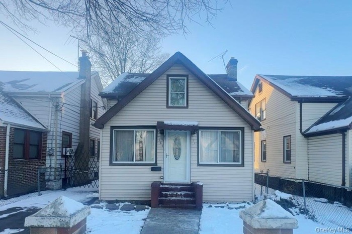 View of front of property with an outdoor fire pit, a chimney, and entry steps