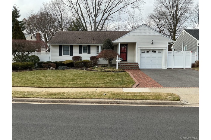 Single story home featuring driveway and an attached garage